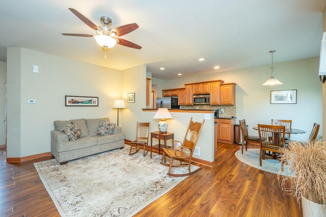 living room with recessed lighting, dark wood finished floors, a ceiling fan, and baseboards