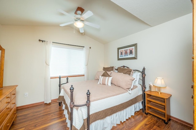 bedroom featuring lofted ceiling, dark wood finished floors, a ceiling fan, and baseboards