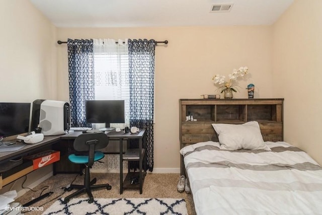 carpeted bedroom with visible vents and baseboards