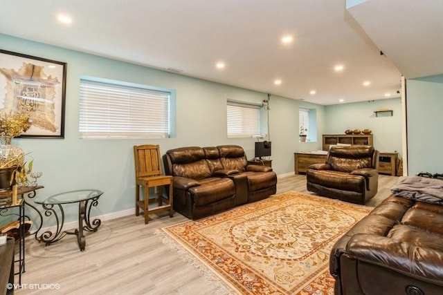 living area featuring baseboards, light wood-type flooring, and recessed lighting