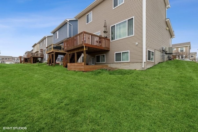 back of property featuring a yard and a wooden deck