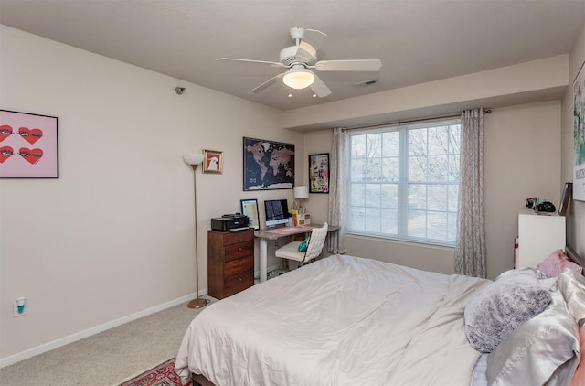 carpeted bedroom featuring baseboards, visible vents, and a ceiling fan