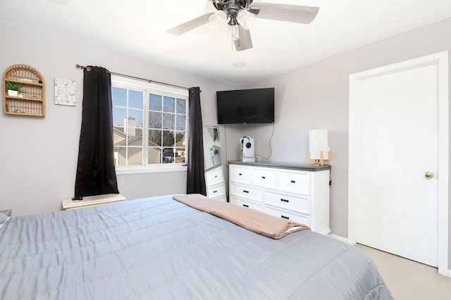 bedroom with a ceiling fan and light carpet