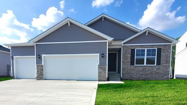 view of front facade with stone siding, a garage, concrete driveway, and a front yard