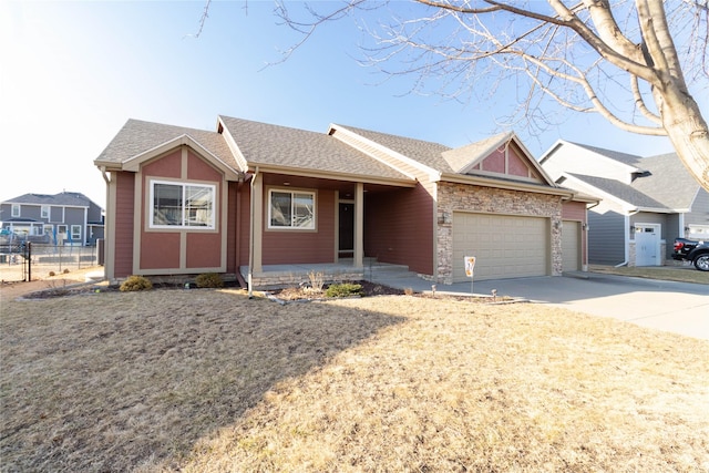 ranch-style house featuring a shingled roof, concrete driveway, an attached garage, fence, and stone siding