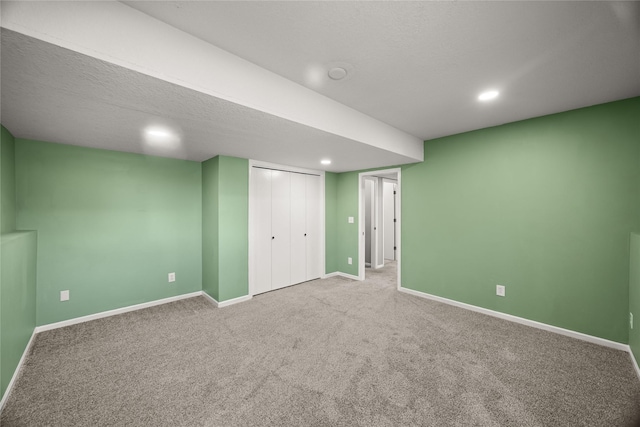 finished below grade area featuring carpet floors, recessed lighting, and baseboards