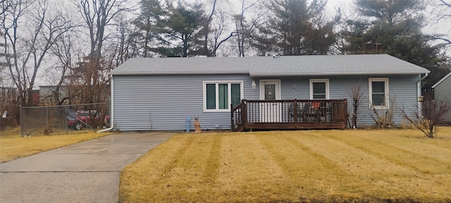 ranch-style house with a front yard and a deck