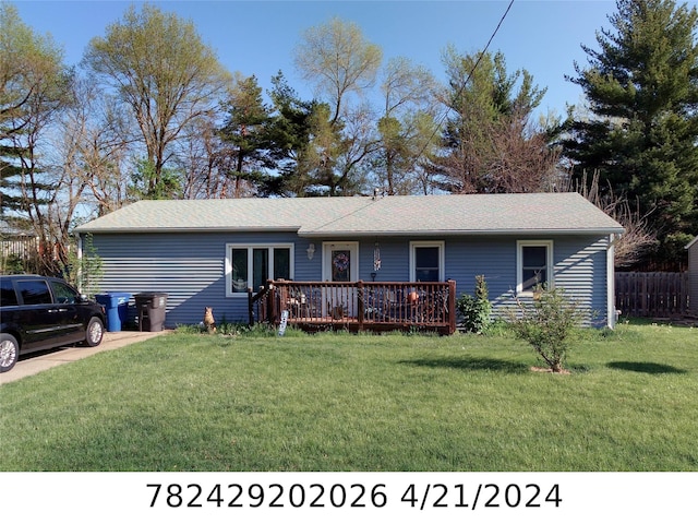 ranch-style home with a front yard and fence