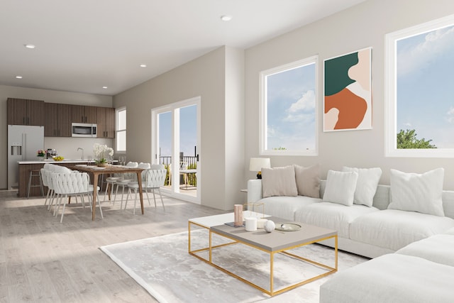 living area featuring light wood finished floors and recessed lighting