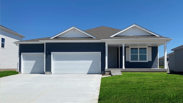 view of front of property featuring an attached garage, covered porch, concrete driveway, roof with shingles, and a front yard