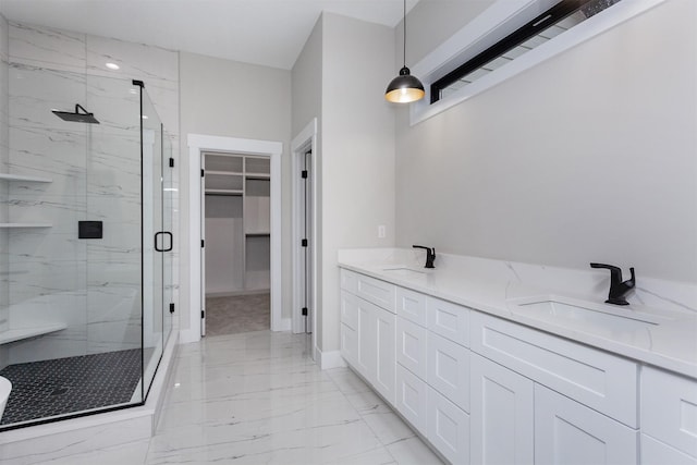 4744 144th St, Urbandale, IA 50323 - bathroom featuring a marble finish shower, marble look tile flooring, a walk in closet, and double vanity