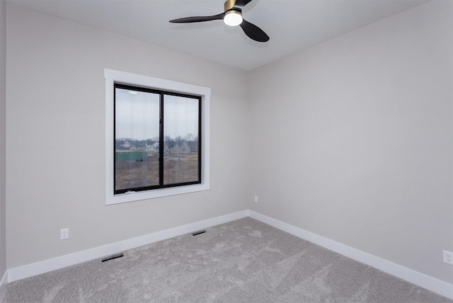 spare room featuring baseboards, visible vents, ceiling fan, and carpet flooring