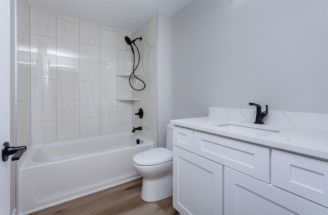 bathroom featuring vanity, bathing tub / shower combination, toilet, and wood finished floors