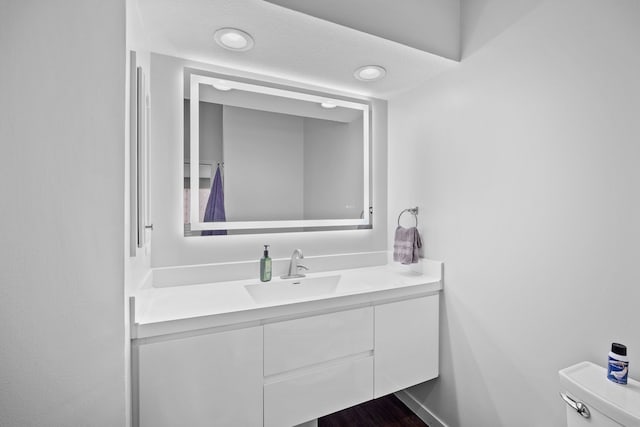 8001 Brookview Dr, Urbandale, IA 50322 - bathroom featuring vanity, toilet, and baseboards