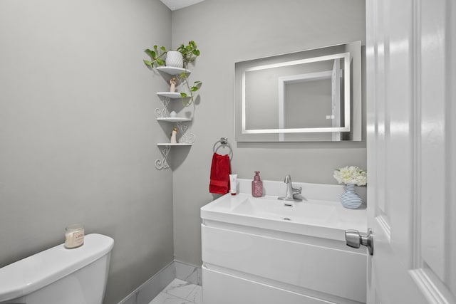 8001 Brookview Dr, Urbandale, IA 50322 - half bath featuring marble look tiles, toilet, baseboards, and vanity