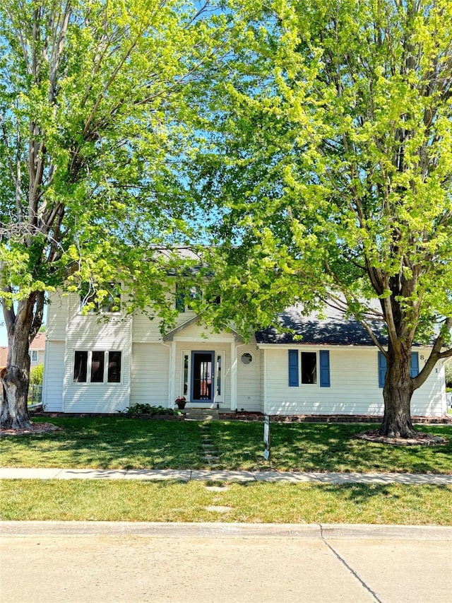 8001 Brookview Dr, Urbandale, IA 50322 - view of property hidden behind natural elements featuring a front lawn