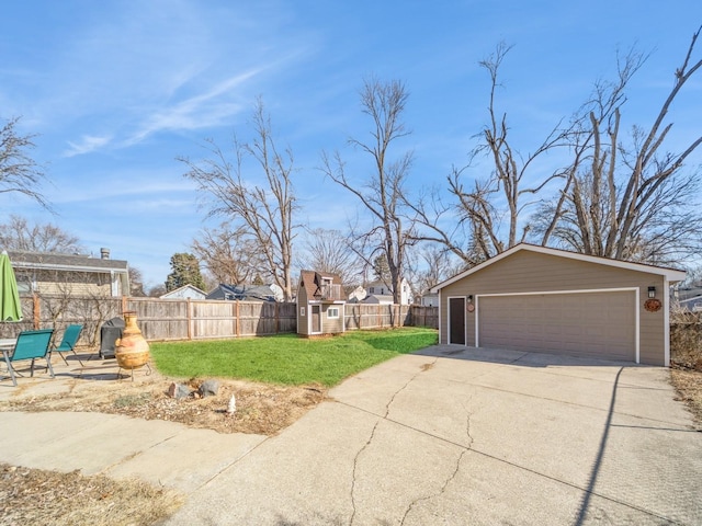 view of yard with an outbuilding, fence, and a detached garage