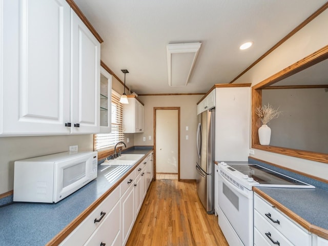 kitchen featuring white appliances, a sink, white cabinetry, light wood-style floors, and ornamental molding