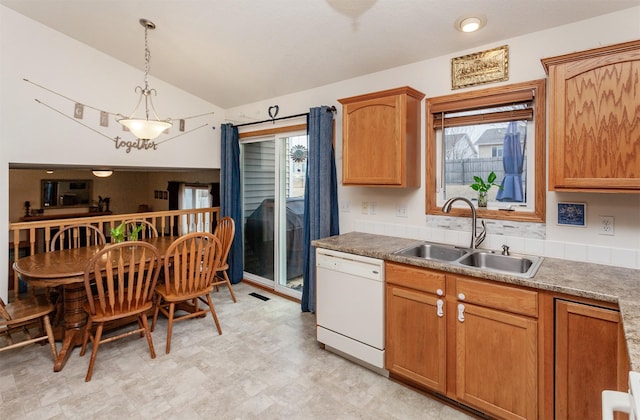 kitchen with a sink, a healthy amount of sunlight, pendant lighting, and white dishwasher