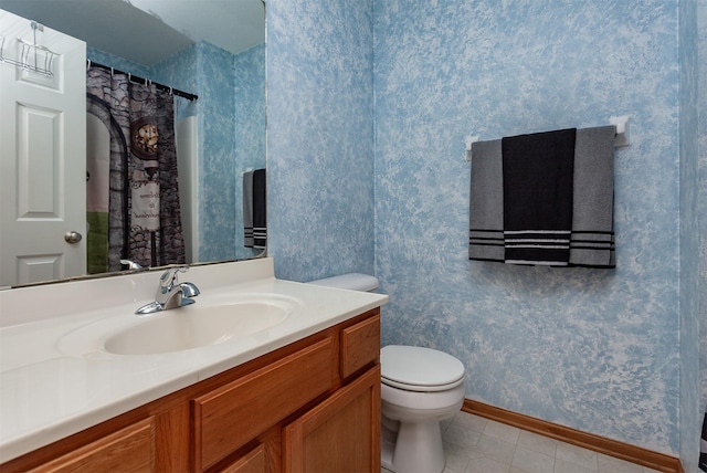 full bath with toilet, tile patterned flooring, wallpapered walls, baseboards, and vanity