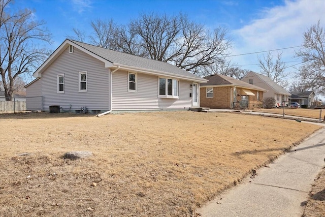 ranch-style house with central AC, a shingled roof, and fence