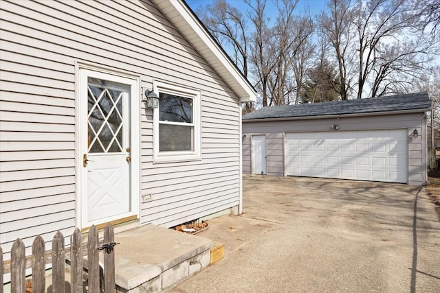 doorway to property featuring a detached garage