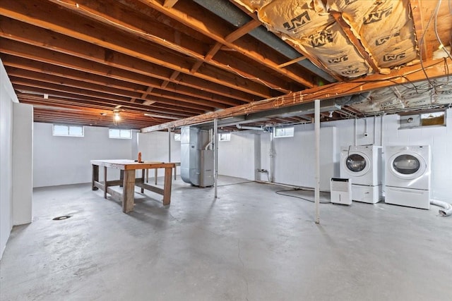 basement with heating unit and separate washer and dryer