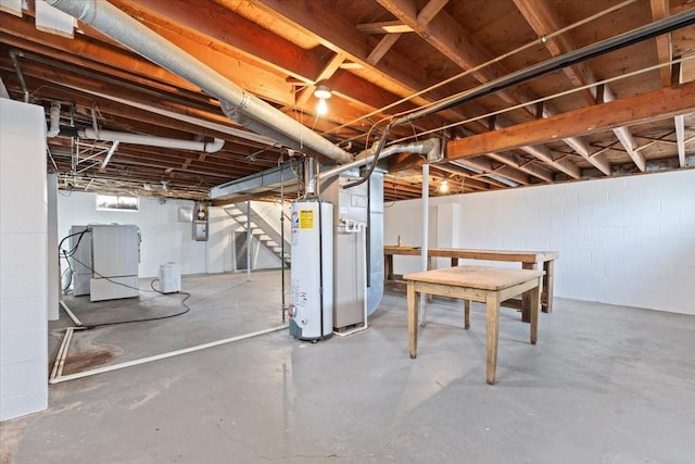 basement with stairway, gas water heater, and refrigerator