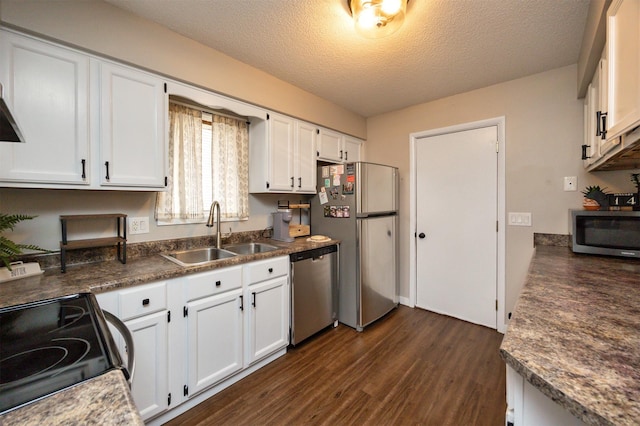 kitchen featuring stainless steel appliances, dark wood-type flooring, a sink, and white cabinets