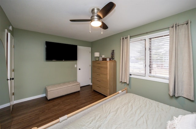 bedroom featuring a ceiling fan, baseboards, and wood finished floors