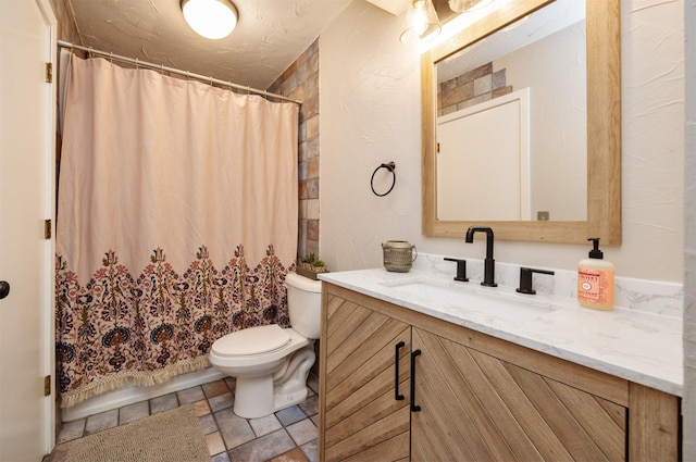 bathroom with curtained shower, vanity, and toilet