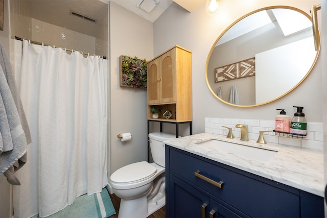 bathroom with curtained shower, visible vents, vanity, and toilet