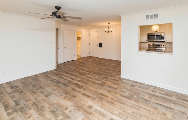 unfurnished living room with baseboards, visible vents, crown molding, and wood finished floors