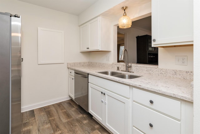 kitchen featuring light stone counters, dark wood-style flooring, a sink, white cabinetry, and appliances with stainless steel finishes