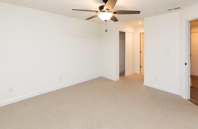 unfurnished bedroom with light carpet, baseboards, visible vents, ceiling fan, and a closet