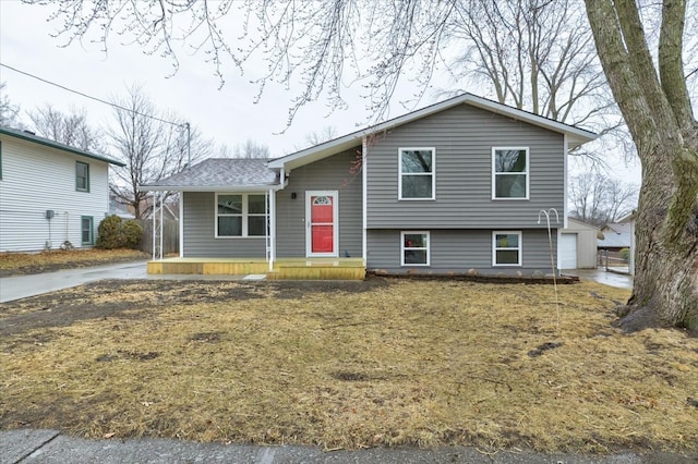 split level home with a garage and an outdoor structure