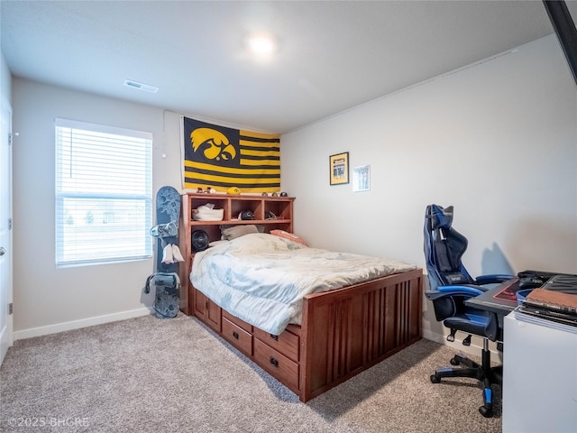 bedroom with carpet floors, visible vents, and baseboards