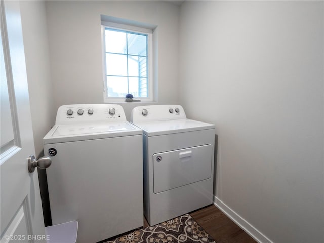 clothes washing area featuring laundry area, independent washer and dryer, dark wood finished floors, and baseboards