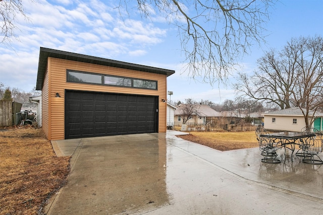 detached garage featuring fence