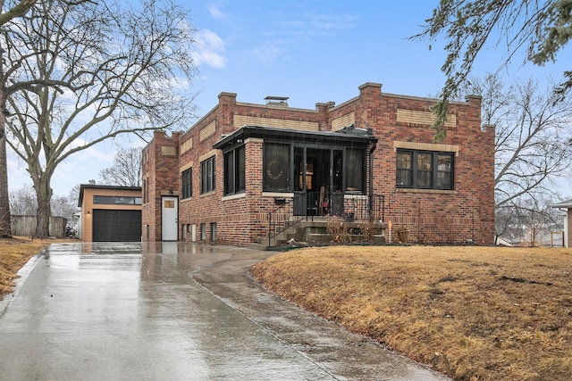 view of front of home with a garage, concrete driveway, and brick siding