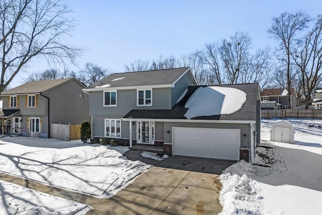 traditional-style home featuring brick siding, fence, driveway, and an attached garage