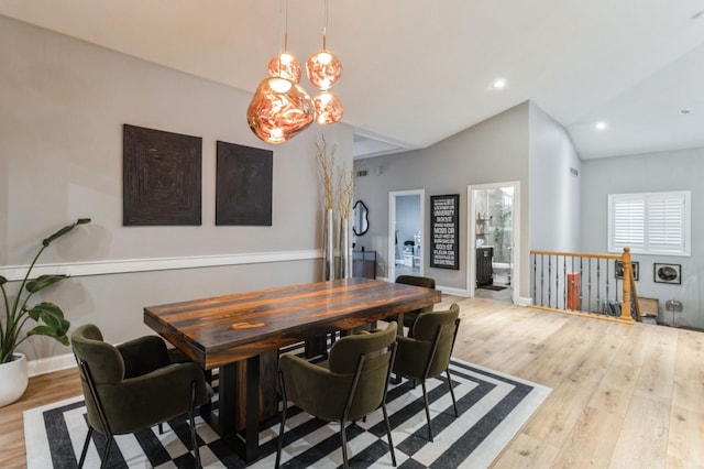 dining space featuring lofted ceiling, baseboards, wood finished floors, and recessed lighting