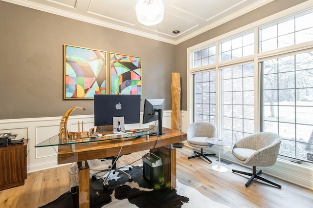 office area with a decorative wall, wainscoting, wood finished floors, and crown molding