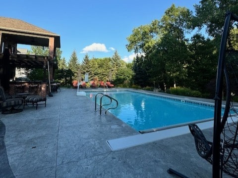 outdoor pool with a patio area