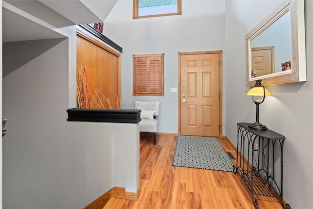 foyer entrance featuring light wood-type flooring and baseboards