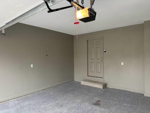 garage with electric panel, baseboards, and a garage door opener