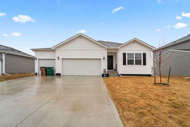 ranch-style house with a garage, concrete driveway, and a front yard