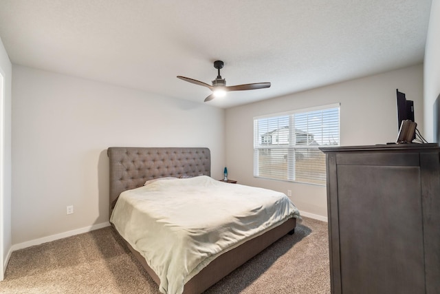 carpeted bedroom with baseboards and a ceiling fan