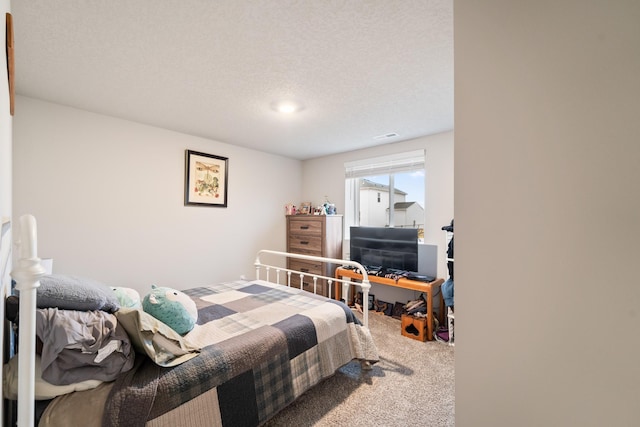 bedroom featuring a textured ceiling and carpet floors