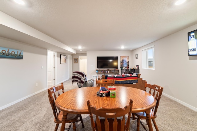 carpeted dining area featuring recessed lighting, a textured ceiling, and baseboards